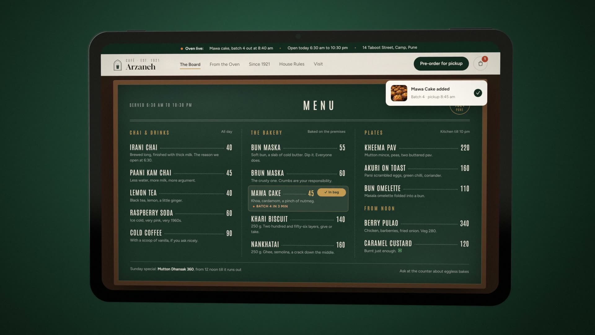 The chalkboard menu on the tablet, with Mawa Cake added and a pickup toast in the corner.