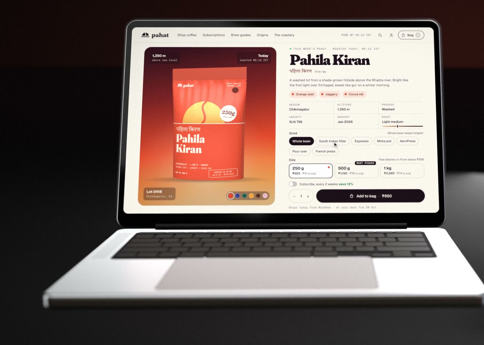The Pahat product page on a laptop: the Pahila Kiran pouch on a dawn gradient with lot and altitude tags, and the name, tasting notes, origin, grind and size options and Add to bag.