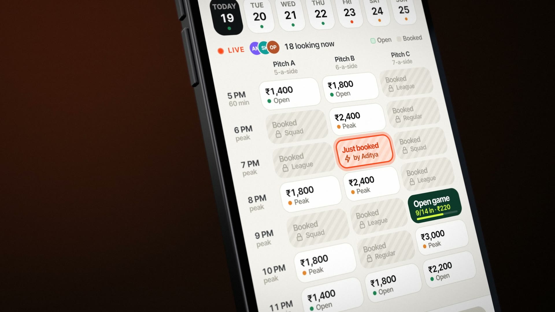 The slot grid on a phone, close: 7 PM on Pitch B marked Just booked by Aditya in orange stripes, the open game at 9 PM in turf green.